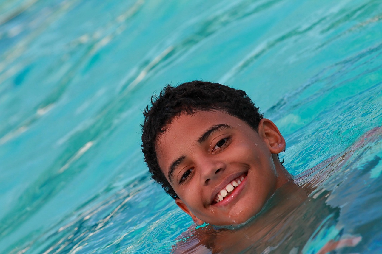 kid smiling in a pool